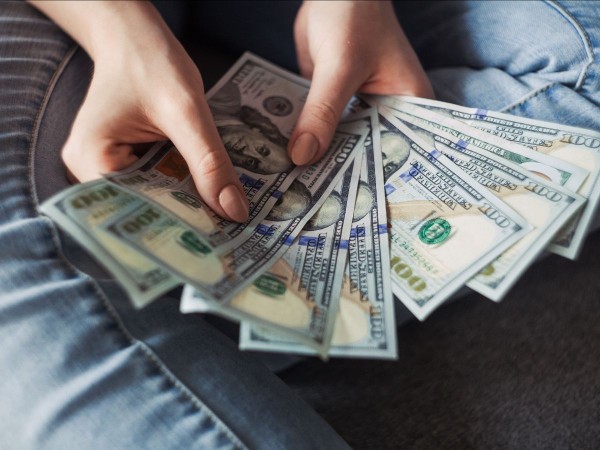 Image of a person's hands holding money