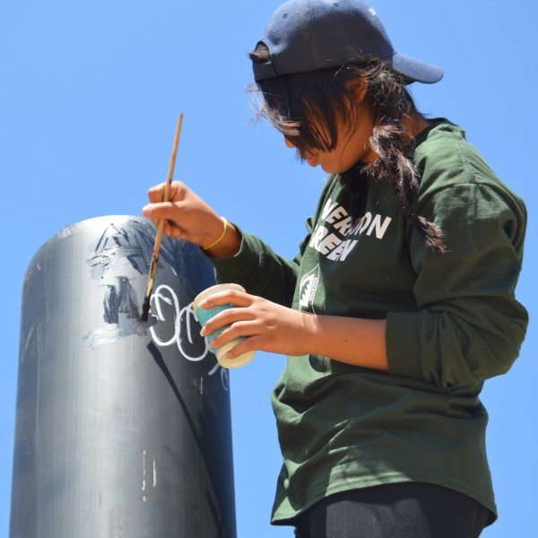 Ranger covering up graffiti