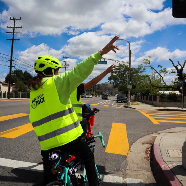 Riders signal to make a right turn